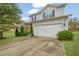 Charming home boasts a two-car garage, manicured shrubs and a well-kept lawn at 3530 Ridge Hill Pkwy, Douglasville, GA 30135