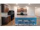 Modern kitchen with a large island, granite countertops, dark cabinets, and sleek, black appliances at 3530 Ridge Hill Pkwy, Douglasville, GA 30135