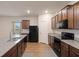 Kitchen features an island, granite counters, and black appliances, offering a sleek and functional space at 3530 Ridge Hill Pkwy, Douglasville, GA 30135