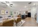 Bright living room featuring hardwood floors, modern furniture, and neutral paint, flowing into the kitchen and dining area at 3530 Ridge Hill Pkwy, Douglasville, GA 30135