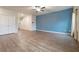 Spacious living room with wood floors, a blue accent wall, and double doors, offering a modern, open feel at 3530 Ridge Hill Pkwy, Douglasville, GA 30135