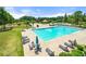 Community pool featuring lounge chairs, umbrellas and palm trees at 3530 Ridge Hill Pkwy, Douglasville, GA 30135