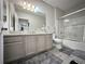 Bright bathroom with dual sinks, granite countertops, and shower-tub combination at 5641 Roswell Rd # 111, Sandy Springs, GA 30342