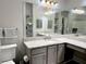 Well-lit bathroom with dual sinks, granite countertops, and a large mirror at 5641 Roswell Rd # 111, Sandy Springs, GA 30342