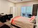 Comfortable bedroom with large windows, desk, and a bed with colorful bedding at 5641 Roswell Rd # 111, Sandy Springs, GA 30342