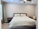 A cozy bedroom with minimalist decor and soft natural light, furnished with a bed, rug and side tables at 5641 Roswell Rd # 111, Sandy Springs, GA 30342