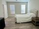 Inviting bedroom with wood-look floors, large windows, and a stylish upholstered bed at 5641 Roswell Rd # 111, Sandy Springs, GA 30342