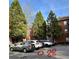 View of the parking lot with surrounding trees and a multi-story residential building at 5641 Roswell Rd # 111, Sandy Springs, GA 30342
