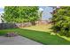 Landscaped backyard featuring a fire pit, manicured lawn, and a wooden fence at 3525 Elder Field Ln, Cumming, GA 30040