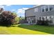View of the home's backyard, featuring a lush lawn, patio and well-maintained landscaping at 3525 Elder Field Ln, Cumming, GA 30040