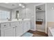 Bathroom featuring dual sinks, white cabinets, and a view to the Primary bedroom at 3525 Elder Field Ln, Cumming, GA 30040