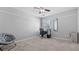 Bedroom features neutral walls, gray carpet, ceiling fan and natural light at 3525 Elder Field Ln, Cumming, GA 30040