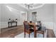 Dining room featuring dark wood floors, wainscoting, and a stylish light fixture at 3525 Elder Field Ln, Cumming, GA 30040