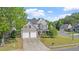 Attractive home with a well-maintained lawn, mature trees, and a double driveway leading to a two-car garage at 3525 Elder Field Ln, Cumming, GA 30040