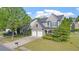 Lovely gray home on a manicured lot, showcasing a two-car garage and inviting curb appeal at 3525 Elder Field Ln, Cumming, GA 30040