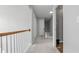 Upstairs hallway featuring neutral walls, gray carpet and white trim throughout at 3525 Elder Field Ln, Cumming, GA 30040