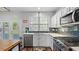 Modern kitchen with white cabinets, stainless steel appliances, and a bright window over the sink at 3525 Elder Field Ln, Cumming, GA 30040