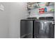 Laundry room featuring newer front load washer and dryer and wire rack shelving at 3525 Elder Field Ln, Cumming, GA 30040