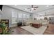 Bright living room with dark wood floors, a white sectional, and large windows at 3525 Elder Field Ln, Cumming, GA 30040