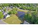 Aerial view of a pond surrounded by trees and houses, a small dock, and an aerator at 3525 Elder Field Ln, Cumming, GA 30040