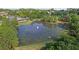 Community pond with fountain and views of the pool and clubhouse, surrounded by mature trees and landscaping at 3525 Elder Field Ln, Cumming, GA 30040