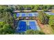 Aerial view of the community's multiple well-maintained tennis courts with lush landscaping and mature trees at 3525 Elder Field Ln, Cumming, GA 30040