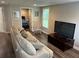 Finished basement with a cozy seating area and a view into another room at 402 Hancock Ct, Woodstock, GA 30188