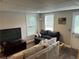 Basement living room with television, sofas and faux wood floors at 402 Hancock Ct, Woodstock, GA 30188