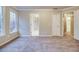 Spacious bedroom featuring neutral tones, soft carpet, and an abundance of natural light from the window at 402 Hancock Ct, Woodstock, GA 30188