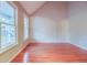 Bedroom with hardwood floors and natural light from large windows at 402 Hancock Ct, Woodstock, GA 30188