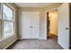 This bedroom has natural light, double closets and neutral walls at 402 Hancock Ct, Woodstock, GA 30188