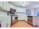 Well-equipped kitchen featuring stainless steel appliances, white cabinetry, and a breakfast bar at 402 Hancock Ct, Woodstock, GA 30188