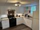 Bright, well-lit kitchenette with white cabinets and granite countertops at 402 Hancock Ct, Woodstock, GA 30188