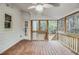 Inviting screened-in porch featuring wood flooring and a ceiling fan at 402 Hancock Ct, Woodstock, GA 30188