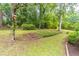 Expansive backyard featuring tiered landscaping, mature trees, and a tranquil setting at 4171 Whispering Forest Sw Ct, Lilburn, GA 30047