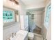 Bathroom featuring a stylish vanity with a sleek sink and a modern, tiled walk-in shower with a built-in bench at 4171 Whispering Forest Sw Ct, Lilburn, GA 30047