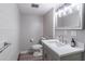 Stylish bathroom featuring a modern vanity, marble countertop, and designer lighting at 4171 Whispering Forest Sw Ct, Lilburn, GA 30047