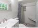 Modern bathroom with walk-in shower, gray tile, and stone shower seat at 4171 Whispering Forest Sw Ct, Lilburn, GA 30047