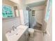 Bathroom featuring a stylish vanity with a sleek sink and a modern, tiled walk-in shower with a built-in bench at 4171 Whispering Forest Sw Ct, Lilburn, GA 30047