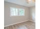 Light-filled bedroom with hardwood floors, a ceiling fan, and a sun-drenched window at 4171 Whispering Forest Sw Ct, Lilburn, GA 30047