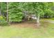 Split-level home with a bright yellow front door and mature trees in the yard at 4171 Whispering Forest Sw Ct, Lilburn, GA 30047