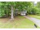 Suburban home with a bright yellow front door, attached two-car garage, and driveway at 4171 Whispering Forest Sw Ct, Lilburn, GA 30047
