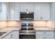 Close-up of kitchen with stainless steel appliances and ample lighting at 4171 Whispering Forest Sw Ct, Lilburn, GA 30047