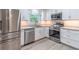 Modern kitchen features stainless steel appliances and granite countertops at 4171 Whispering Forest Sw Ct, Lilburn, GA 30047