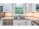 Bright kitchen features a stainless steel sink, modern appliances, and granite countertops at 4171 Whispering Forest Sw Ct, Lilburn, GA 30047
