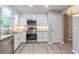 Bright kitchen boasts new cabinets, countertops, and stainless steel appliances at 4171 Whispering Forest Sw Ct, Lilburn, GA 30047