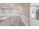 Open living area with modern flooring, wainscotting and a stainless refrigerator at 4171 Whispering Forest Sw Ct, Lilburn, GA 30047