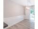 Well-lit living room with white wainscoting and access to the outdoors at 4171 Whispering Forest Sw Ct, Lilburn, GA 30047