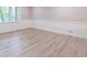 Bright living room with large window, wainscotting, and light-colored flooring at 4171 Whispering Forest Sw Ct, Lilburn, GA 30047