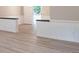 Bright living room features new flooring and white wainscoting detail at 4171 Whispering Forest Sw Ct, Lilburn, GA 30047